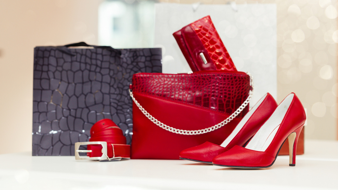 Pair of a red elegant leather women shoes with high heels, women purse, wallet, belt and shopping bags